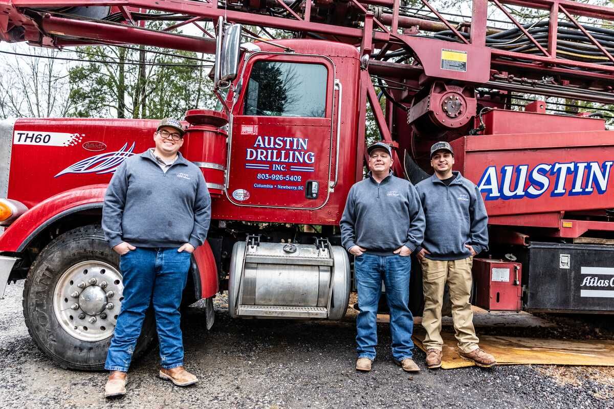 Austin Drilling crew standing in front of their drilling rig